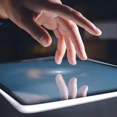 Close-up of hand interacting with touchscreen display, representing budget-friendly AV touchscreen rentals for Atlanta events and expos